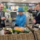 Britain’s Queen Elizabeth II looks at food hampers during a visit to a Waitrose supermarket in the town on October 27, 2016 in Poundbury, England. Photo via Getty Images.